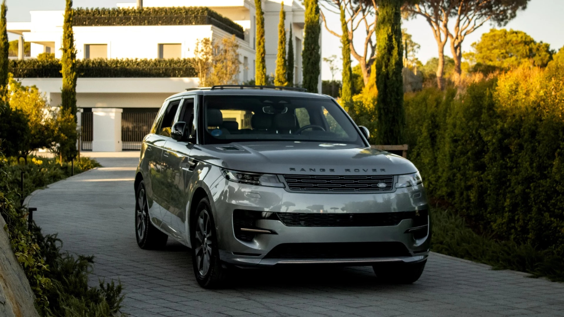 黃昏時分停在別墅車道上的 Range Rover Sport
